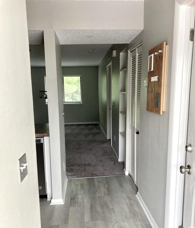 Hall featuring carpet flooring