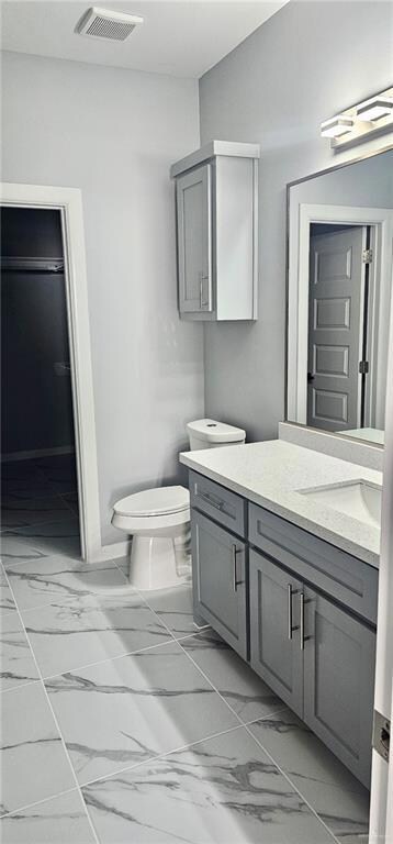 Bathroom with vanity and marble look tiles