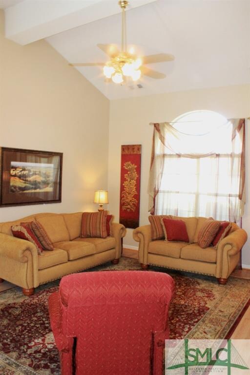 Living room with wood laminate flooring and vaulte