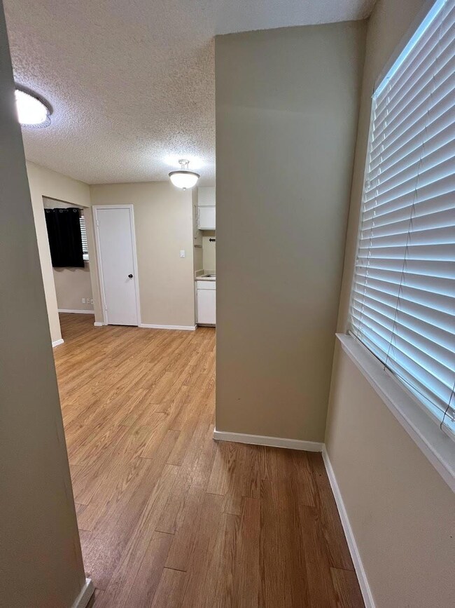 Empty room featuring baseboards, light wood-type 