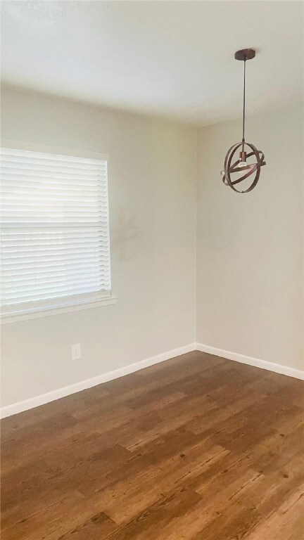 Spare room with wood finished floors, baseboards,