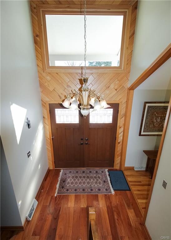 Foyer highlights dramatic wood accents and soaring