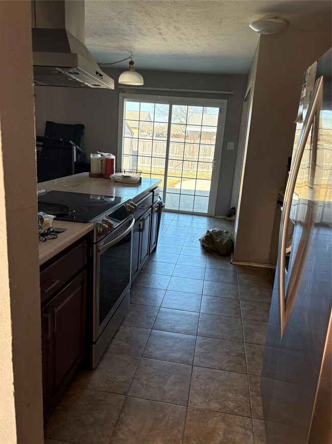 Kitchen featuring dark tile patterned floors, rang