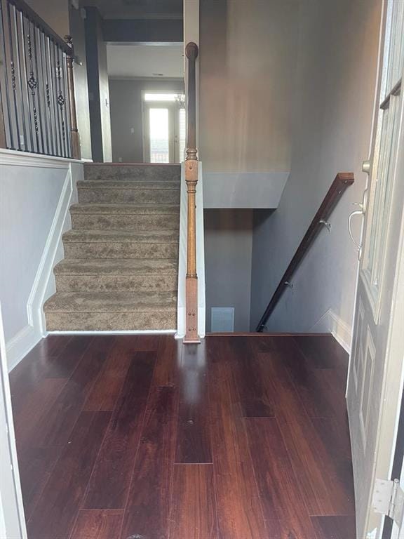 Staircase featuring hardwood / wood-style flooring