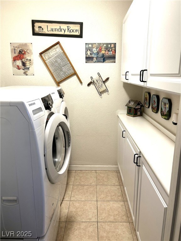 Laundry room featuring cabinet space, washing mach
