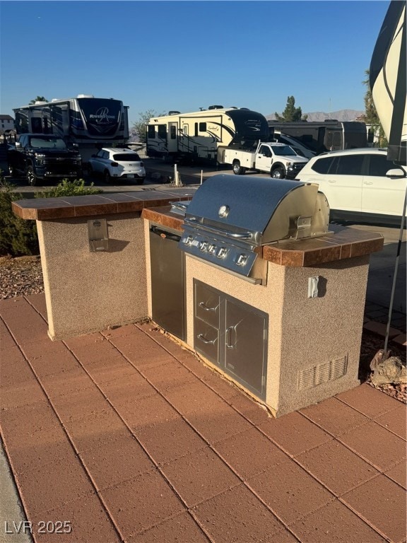 View of patio featuring an outdoor kitchen