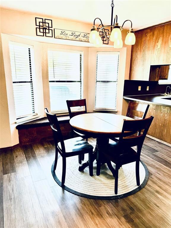 Dining area with an inviting chandelier, hardwood 