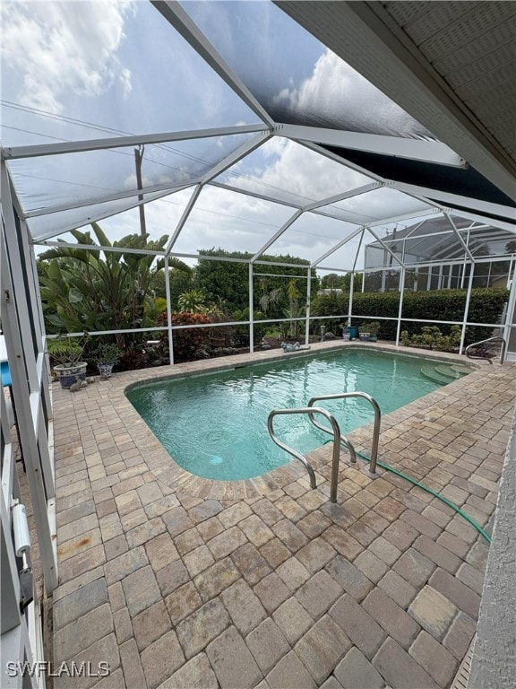 Swimming pool featuring paver patio area and scree