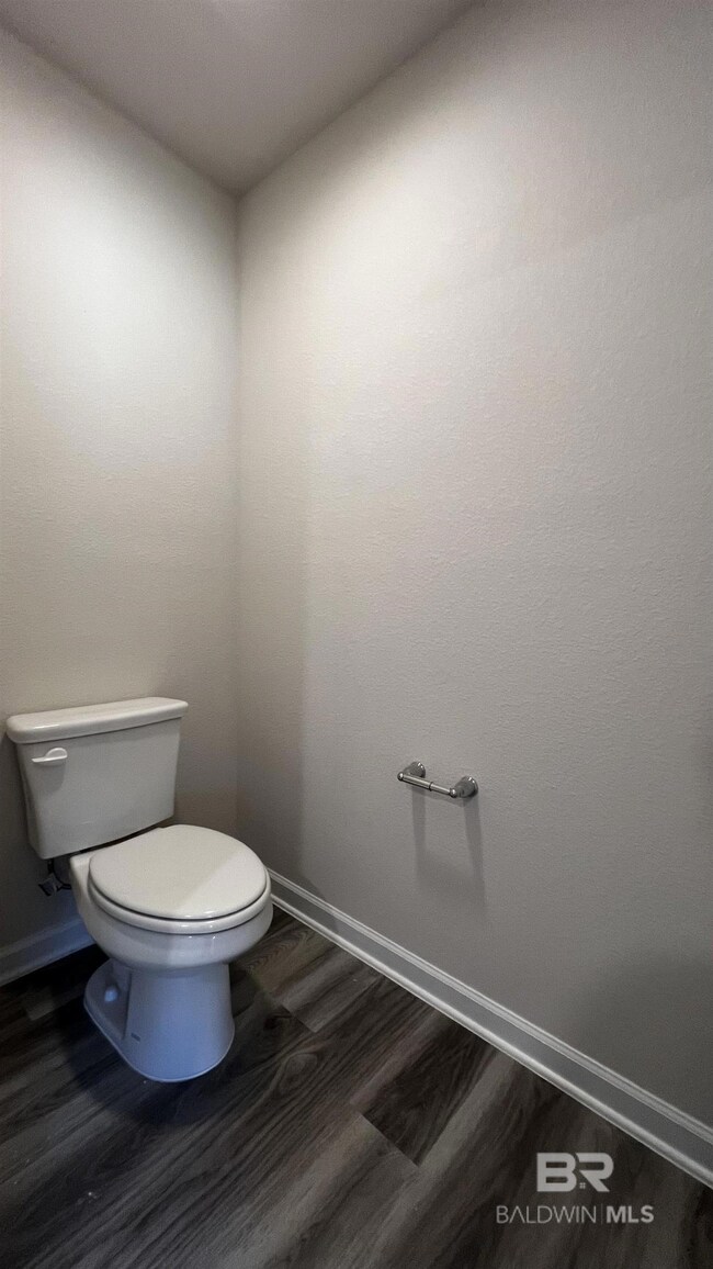 Bathroom featuring toilet and wood-type flooring