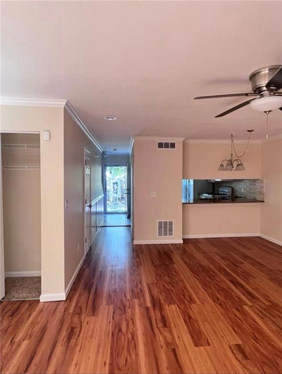 Unfurnished living room featuring ceiling fan, vis