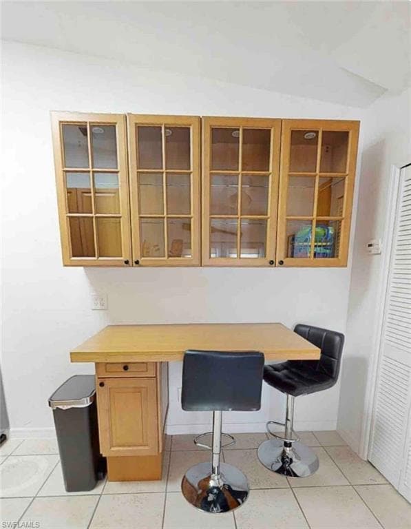 Home office with light tile patterned flooring and