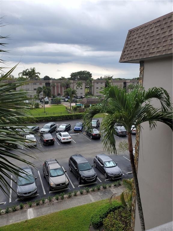 VIEW FROM CATWALK OF THE PARKING LOT, POOL, CLUBHO