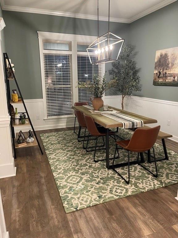 Dining room with a wainscoted wall, crown molding, and dark wood-type flooring