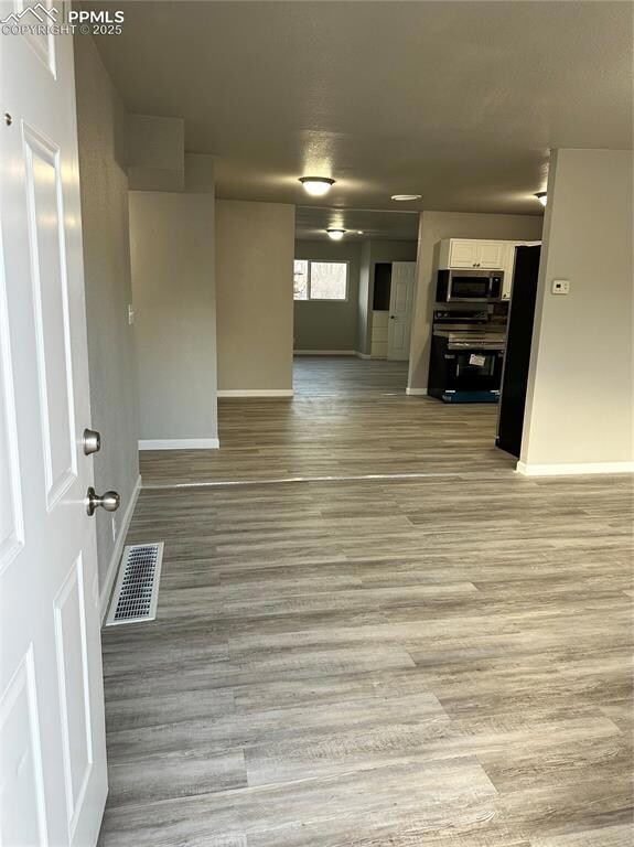 Unfurnished room featuring light wood finished flo