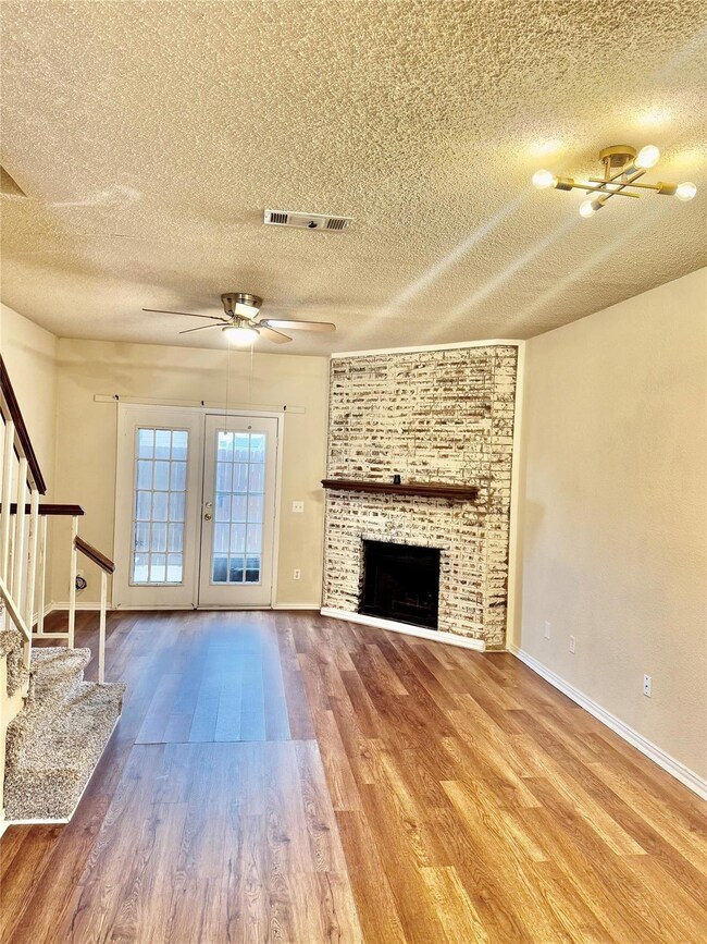 Unfurnished living room featuring visible vents, a