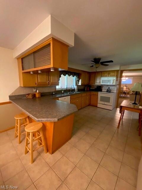 Kitchen featuring light tile floors, range, brown 