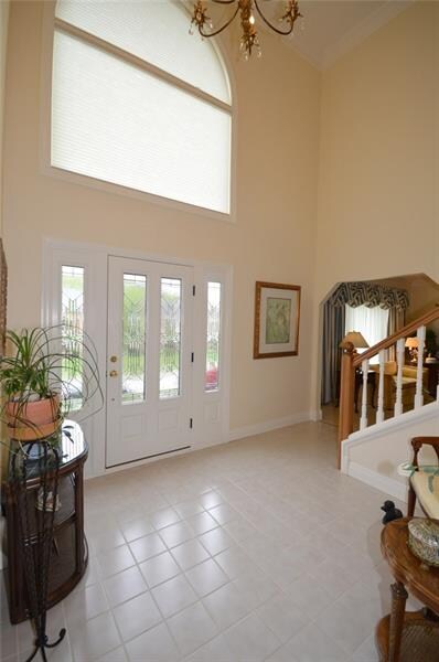 Two story entry features a Palladium window with r