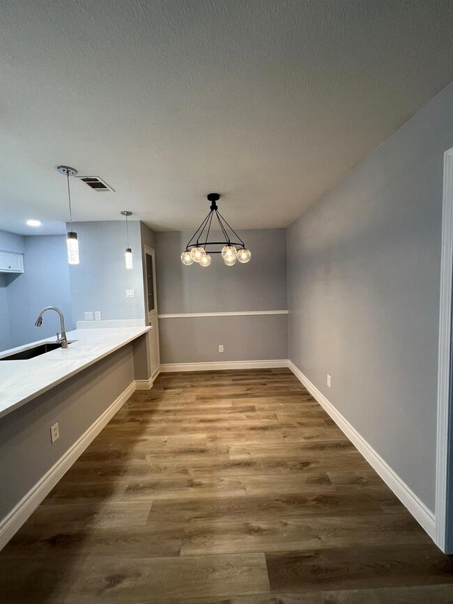 Unfurnished dining area featuring a sink, a textu