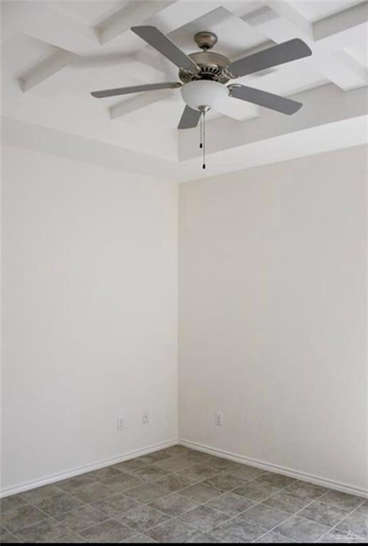 Spare room featuring ceiling fan, beamed ceiling, and coffered ceiling