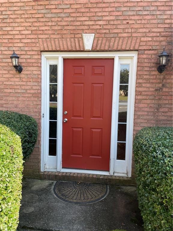 Entrance to property with brick siding