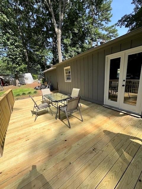 Deck featuring outdoor dining area and french doors