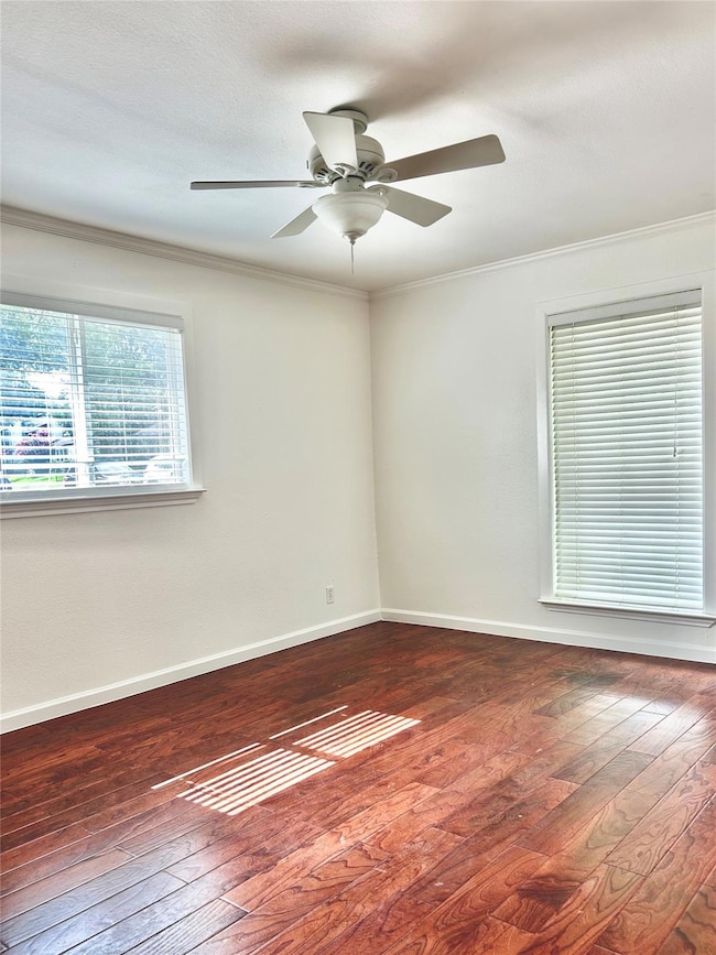 Spare room with dark wood finished floors, orname