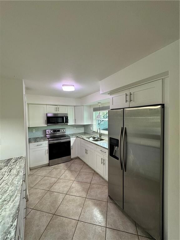 Kitchen featuring light tile patterned flooring, s