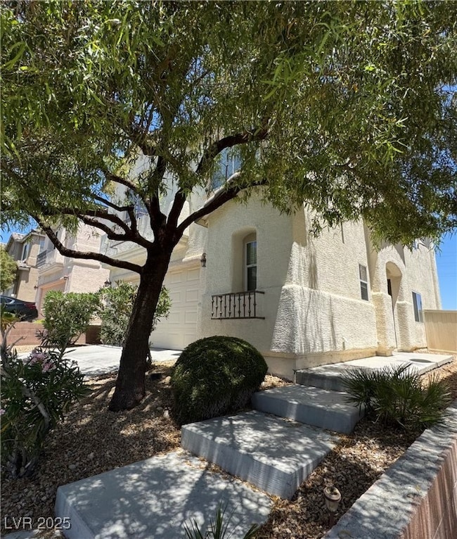 View of side of home featuring stucco siding and a