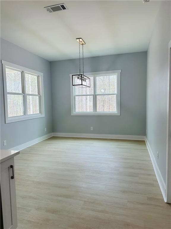 Spare room with light wood finished floors, basebo