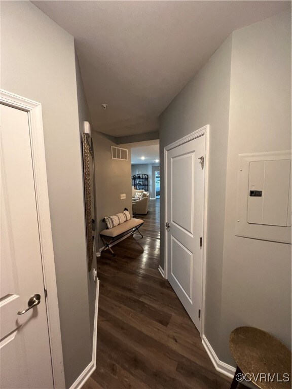 Hall featuring electric panel and dark hardwood /