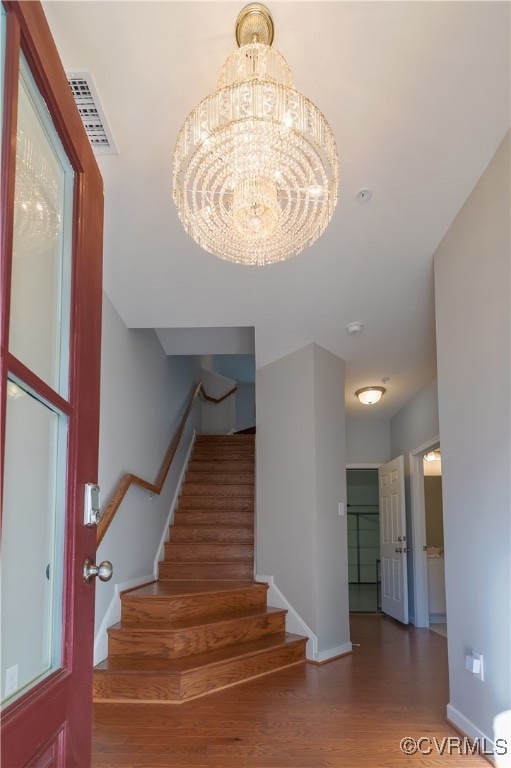 Staircase featuring dark wood-type flooring and an
