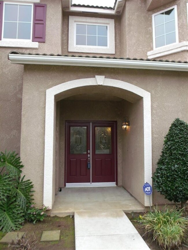 Welcoming sheltered porch with double door entry.