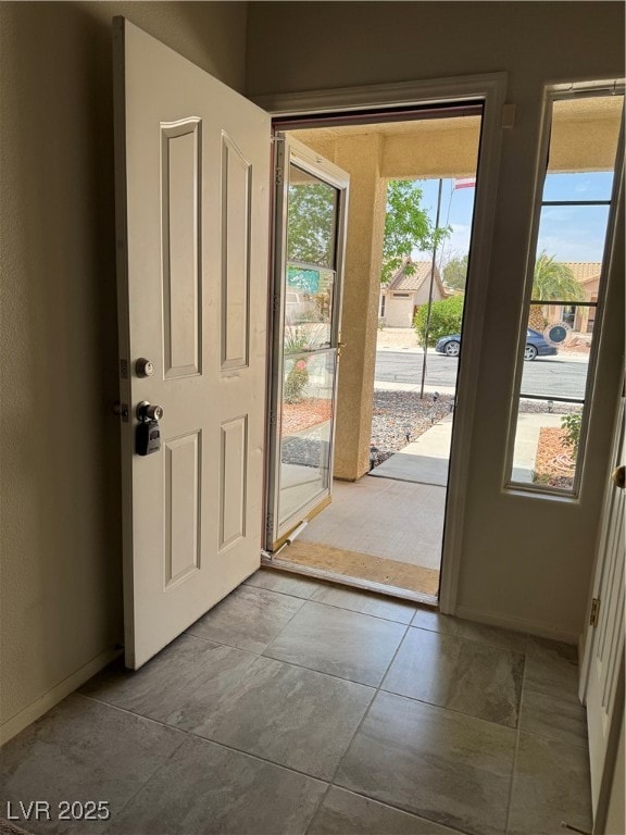 Doorway featuring baseboards