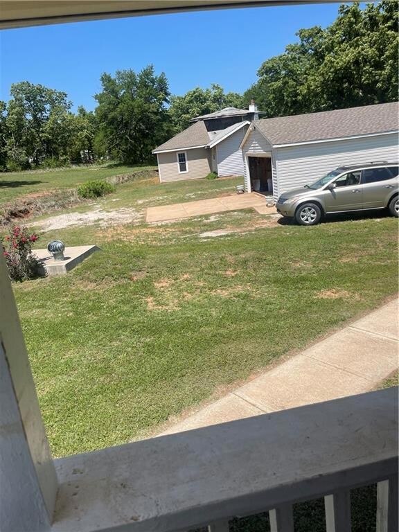 Looking south from house to garage and 2 story hou
