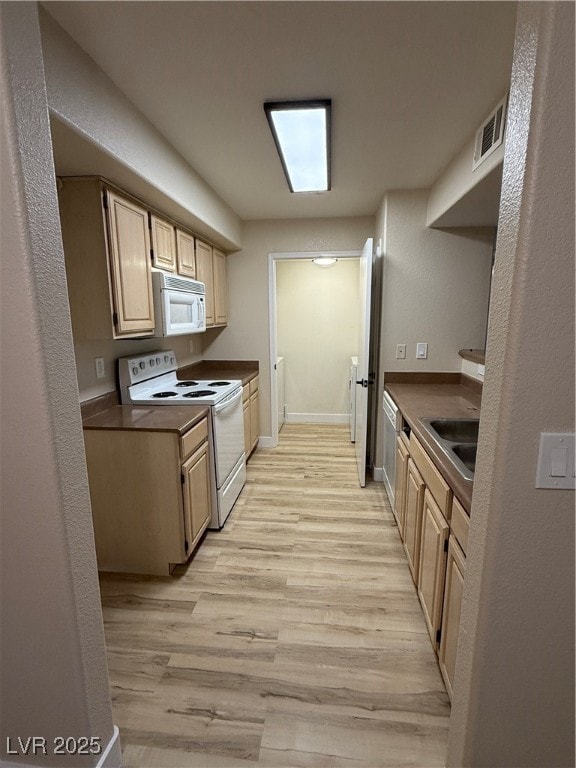 Kitchen with visible vents, dark countertops, stov