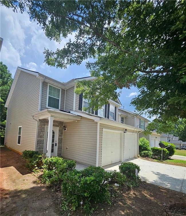 Traditional-style house with driveway, and an attached garage