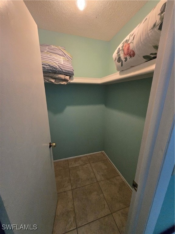 Walk in closet featuring tile patterned flooring