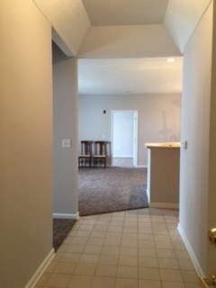 Foyer with tray ceiling and ceramic tile