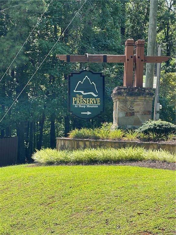 Community / neighborhood sign with a yard