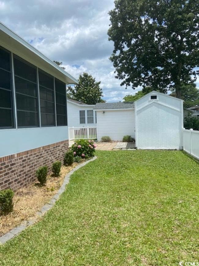 View of fenced yard with a sunroom