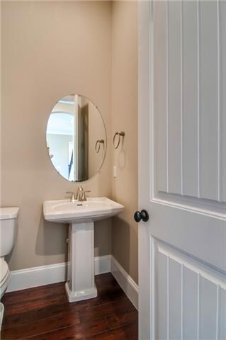 A powder room is located  on the first floor.  Photo  is an example of builder's work. Actual home built may vary. 