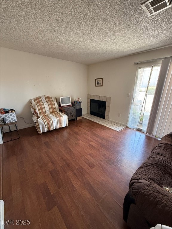 Living room with wood finished floors, a tiled fir