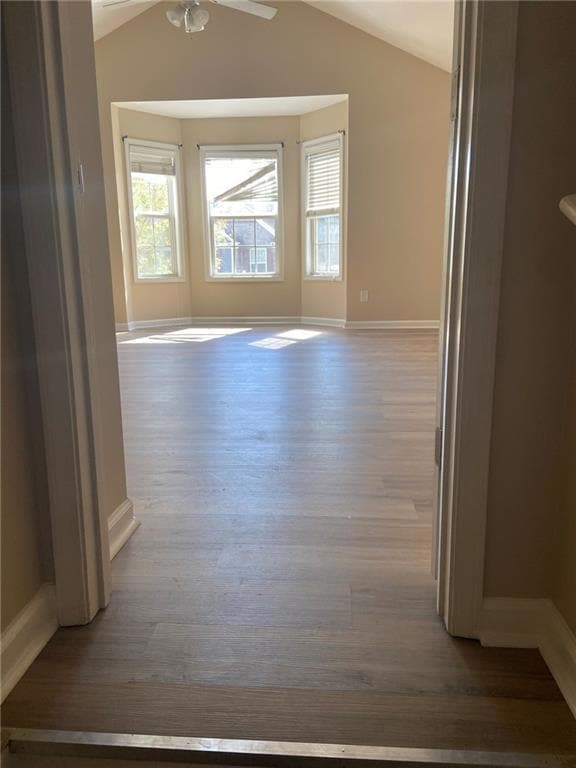 Unfurnished room with ceiling fan, baseboards, vau