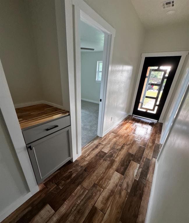 Hall featuring dark wood finished floors