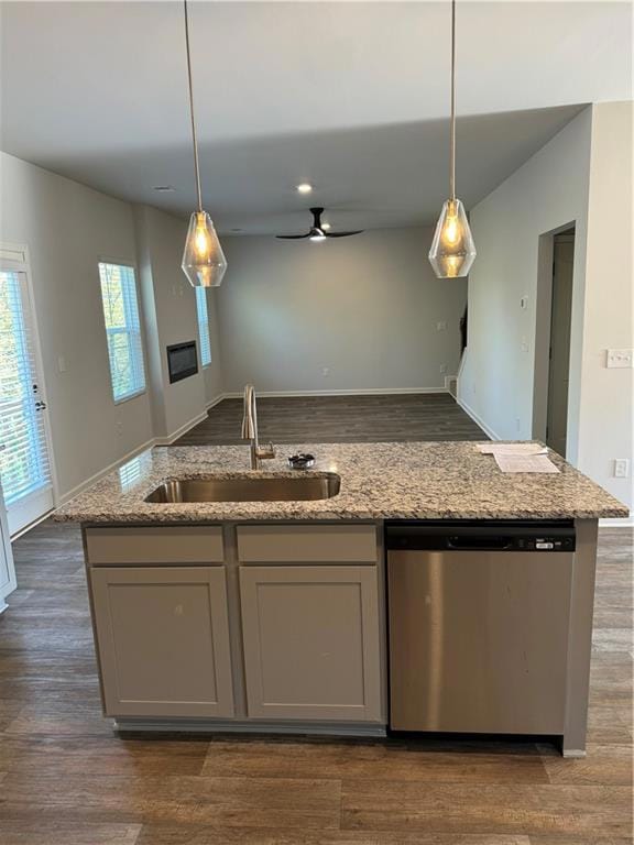 Kitchen featuring light stone countertops, sink, d