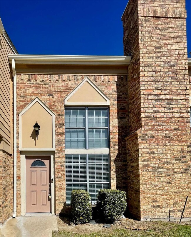 View of exterior entry featuring brick siding