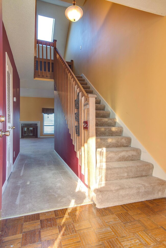 Entry way with wood flooring with stairs leading to the second level