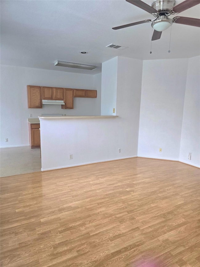 Unfurnished living room with light wood-type floo
