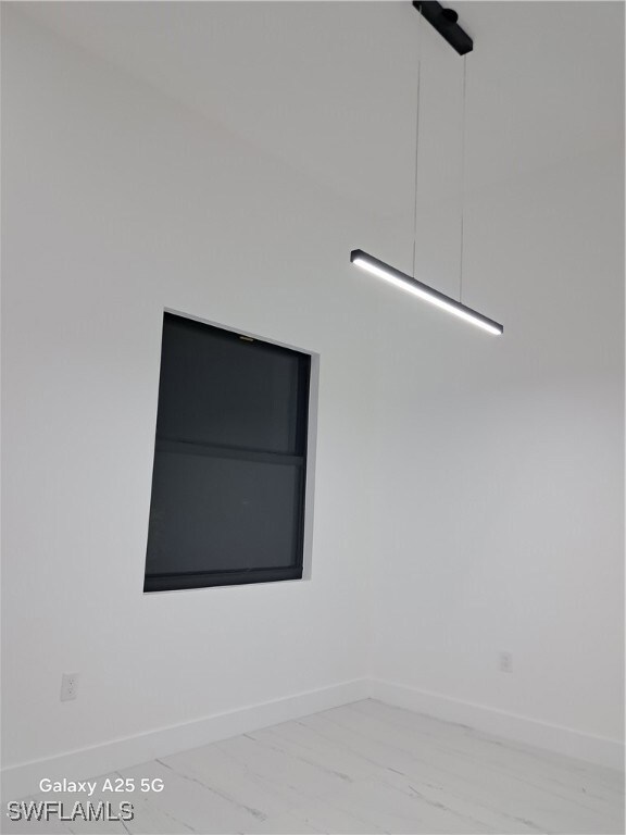 Unfurnished room featuring marble finish floors an