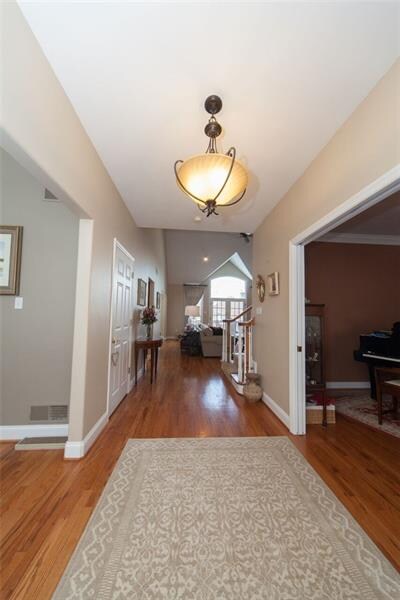 The gleaming floors lead to left..formal dining ro